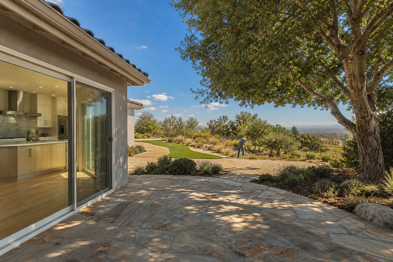 Rear view of upgraded single-family home with quartz finishes, mature shade tree, and level patio in Canyon Country neighborhood.
