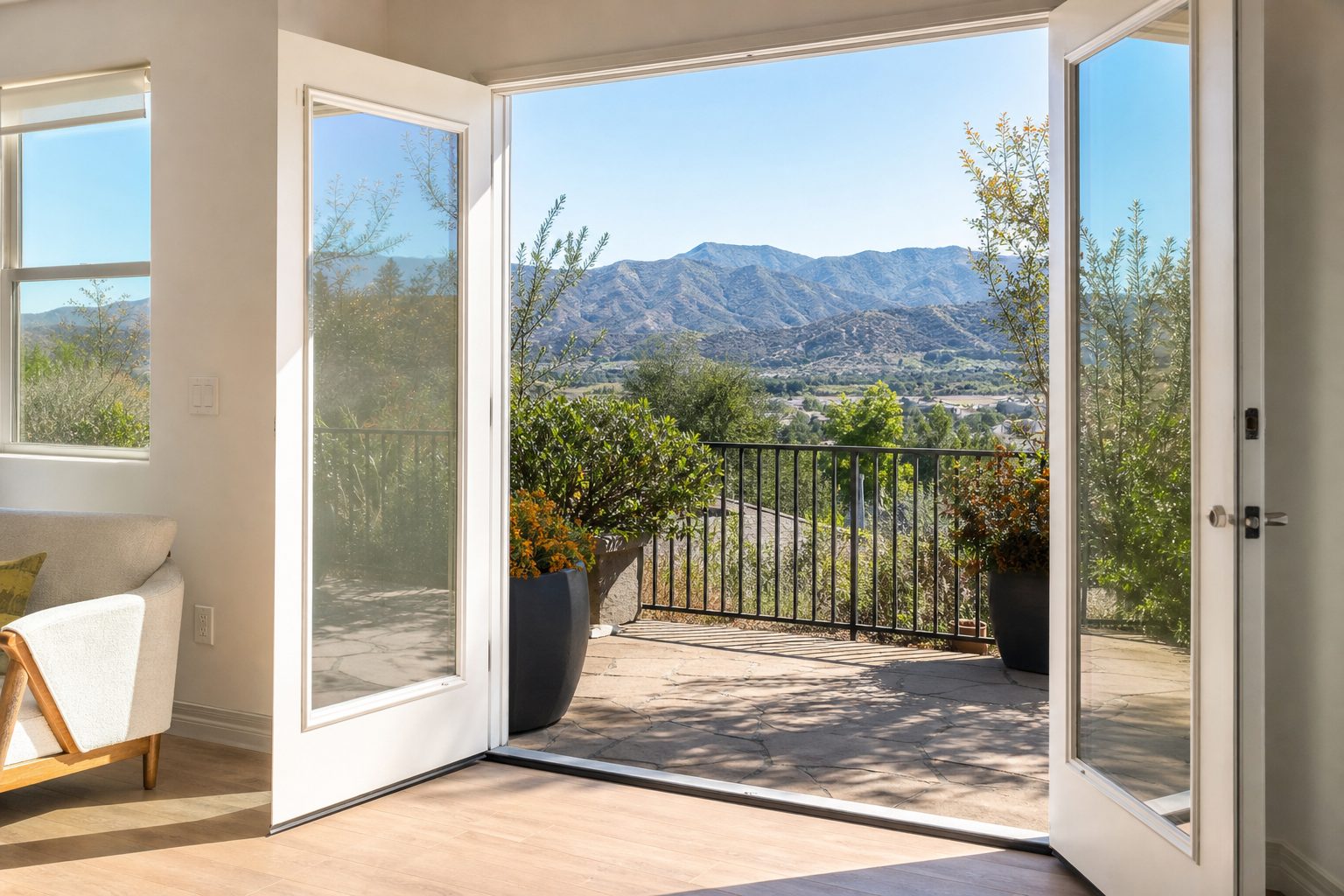 Modern Valencia condo patio with French doors, mountain views, and canyon landscape in Santa Clarita visible beyond.