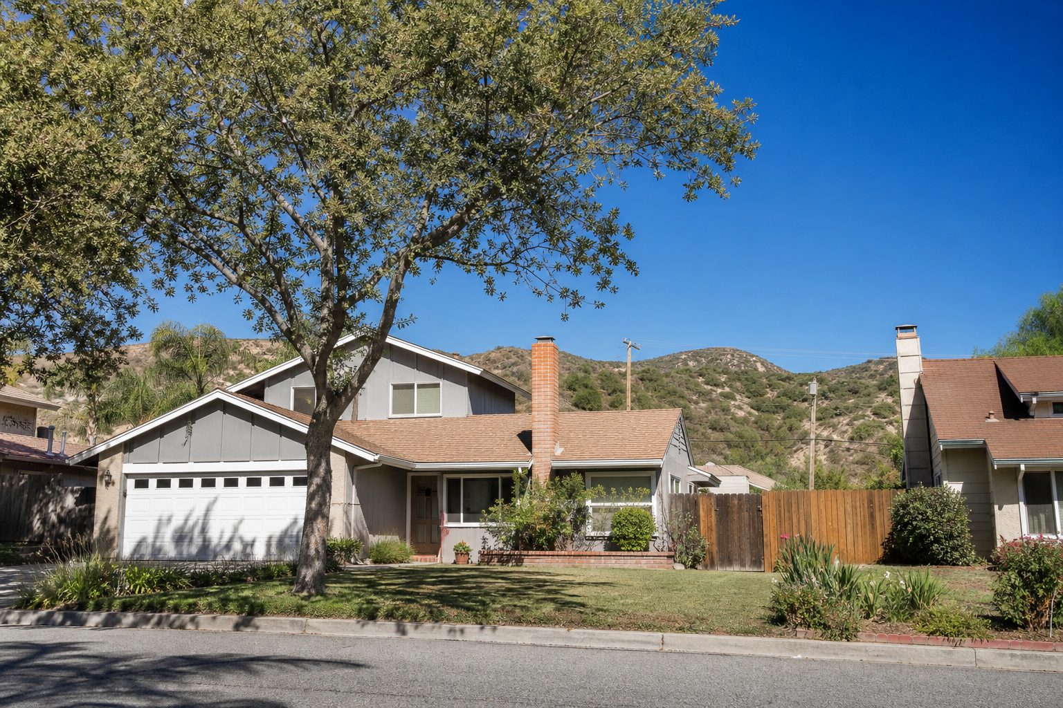 Established Saugus neighborhood with mature trees and older single-family homes, minimal community infrastructure.
