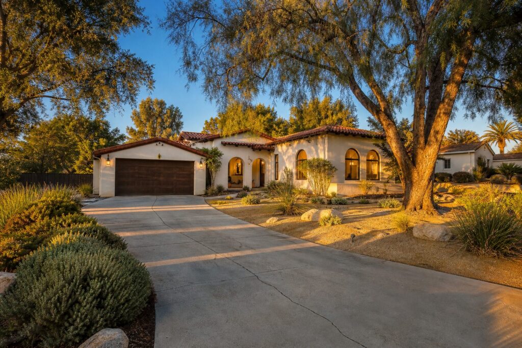 Spanish Colonial Revival home with mature pepper trees and xeriscape landscaping in Granada Hills, San Fernando Valley.