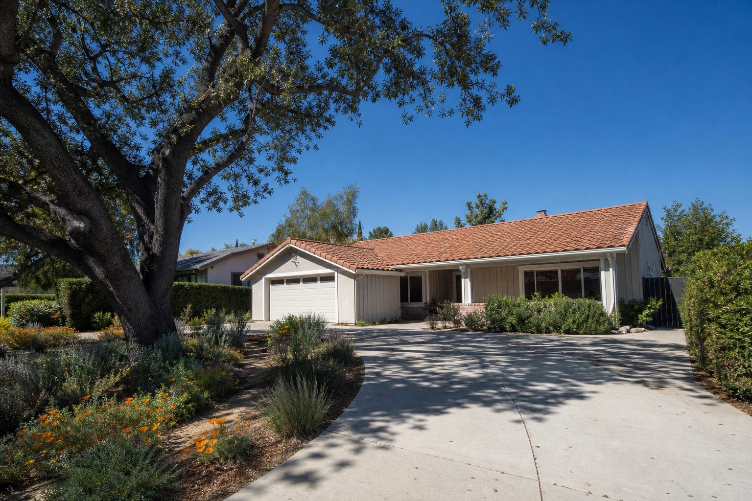 Updated 1970s ranch home with mature oak tree and drought landscaping in Granada Hills South.